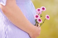 Pregnant woman cradling her belly