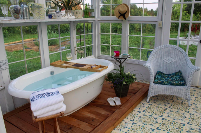 Relaxing tub in a windowed room.