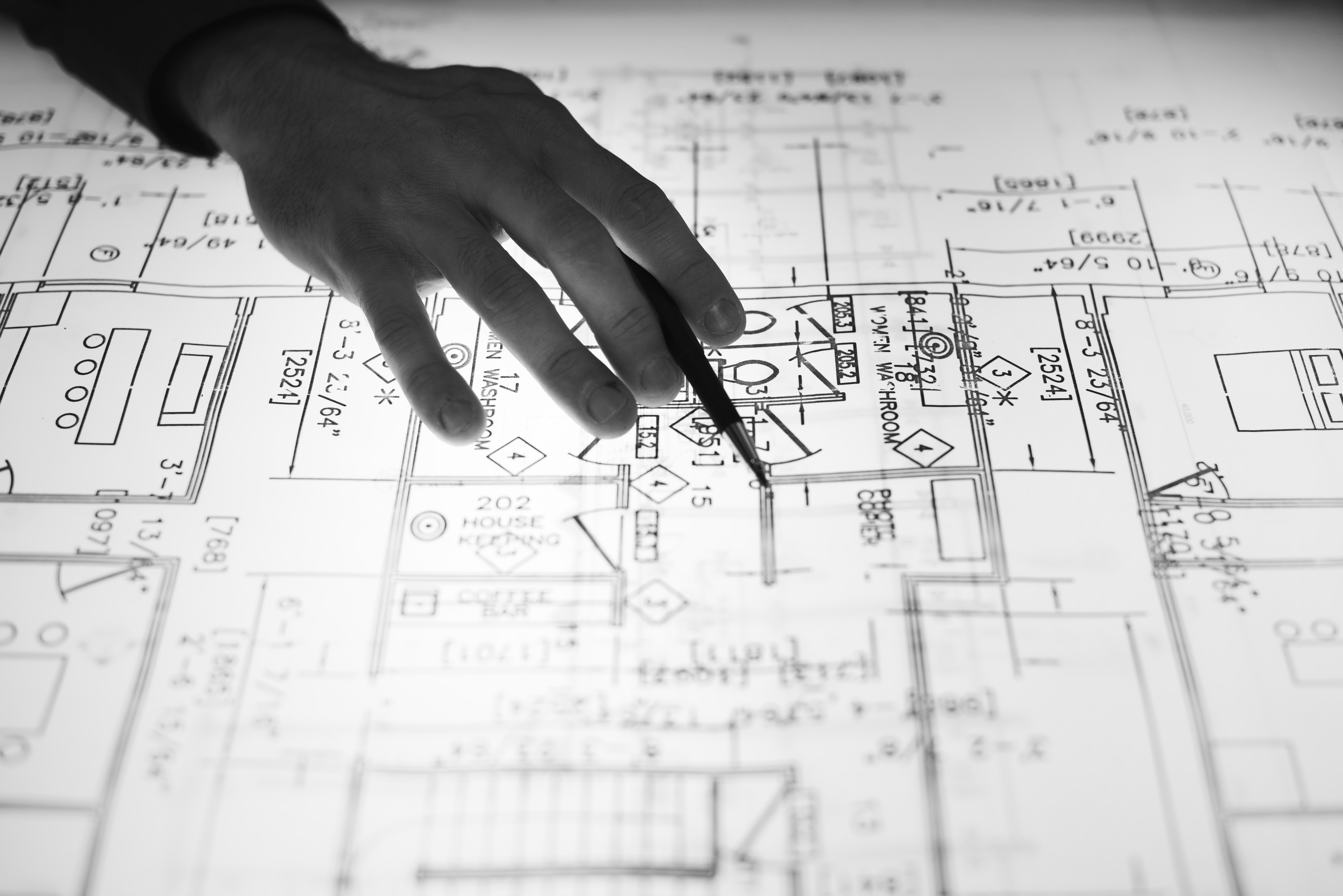 Architect's hand over an architectural drawing.