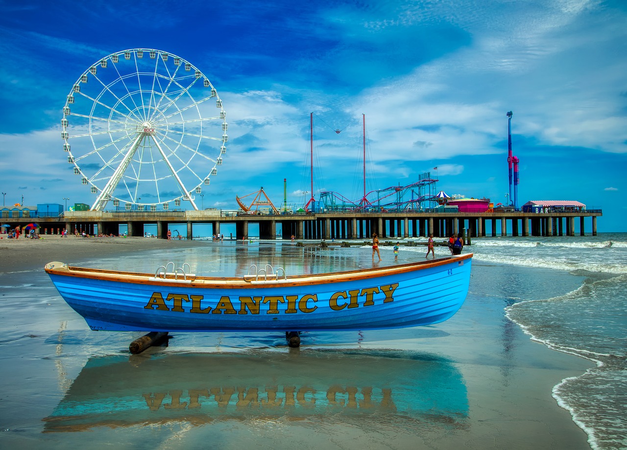 Colorful blue boat docked in Atlantic City, New Jersey, with a ferris wheel in the background.