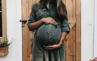 Pregnant woman cradling her belly