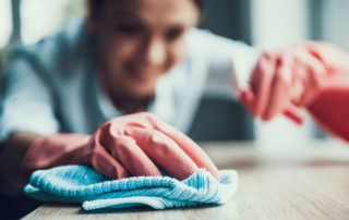Woman cleaning with gloves on
