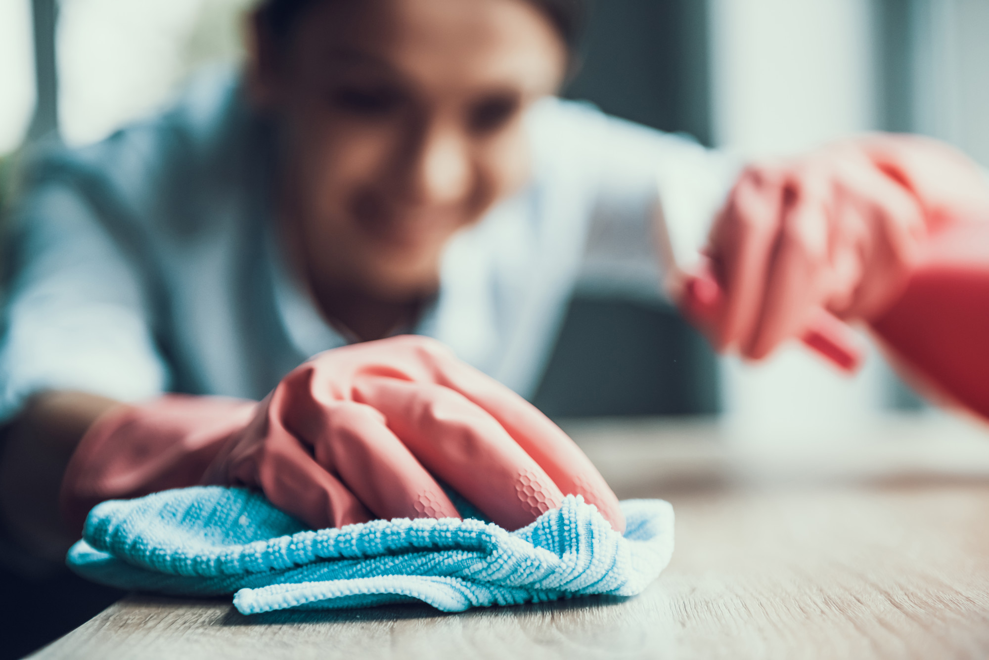 Woman cleaning with gloves on