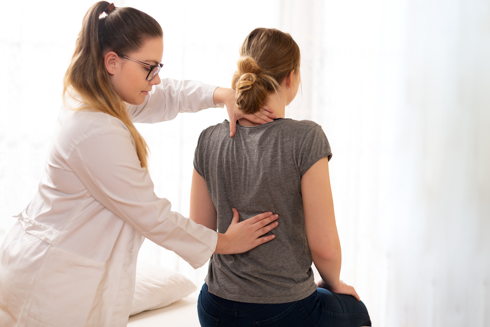 Chiropractor adjusting a woman's back